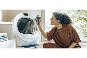 woman petting cat in Litter-Robot 5 HSA/FSA eligible automatic litter box