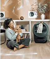 wcom woman holding cat next to cat using Litter-Robot EVO Reconditioned thumbnail