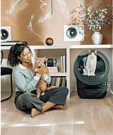 Whisker.com cat using Litter-Robot EVO near woman and orange tabby thumbnail