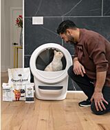 cat in white Litter-Robot 4 with greatlitter odortrap and waste drawer liners on the side and owner looking in thumbnail