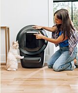 Woman placing the Litter-Robot 4 shield on the automatic litter box thumbnail