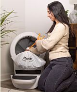 Whisker.com woman removing Litter-Robot Waste Drawer Liner thumbnail
