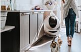 Cats walking near a litter robot 3 connect unit in a mudroom setting Thumbnail