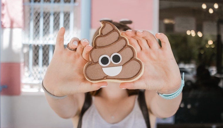 poop emoji held between two hands