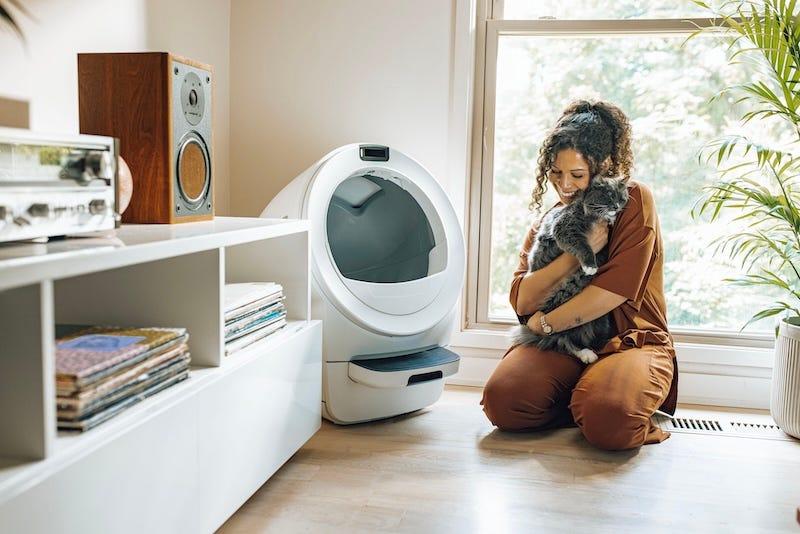 litter robot 5 with woman hugging a cat