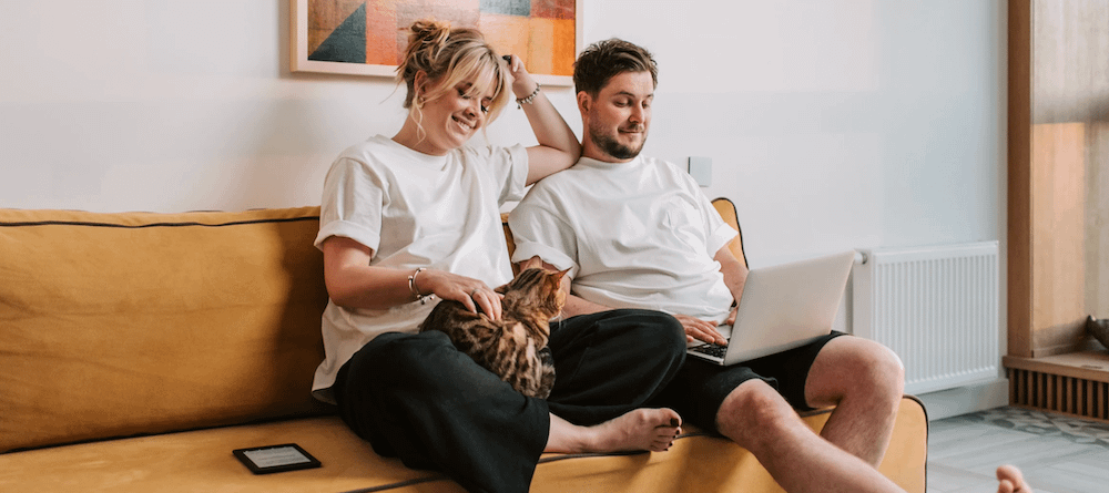 couple with cat and laptop