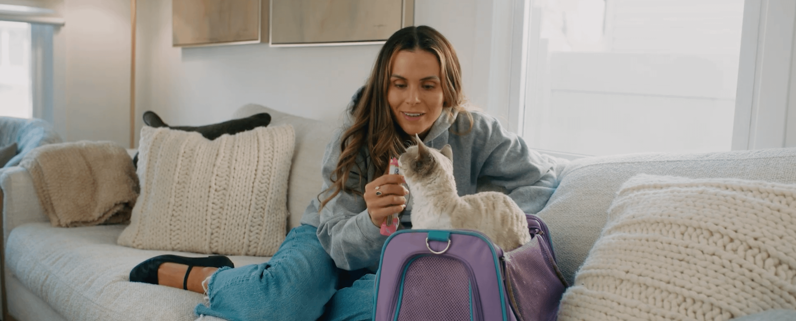 Dr. Anna Foster with Devon Rex cat in cat carrier for travel