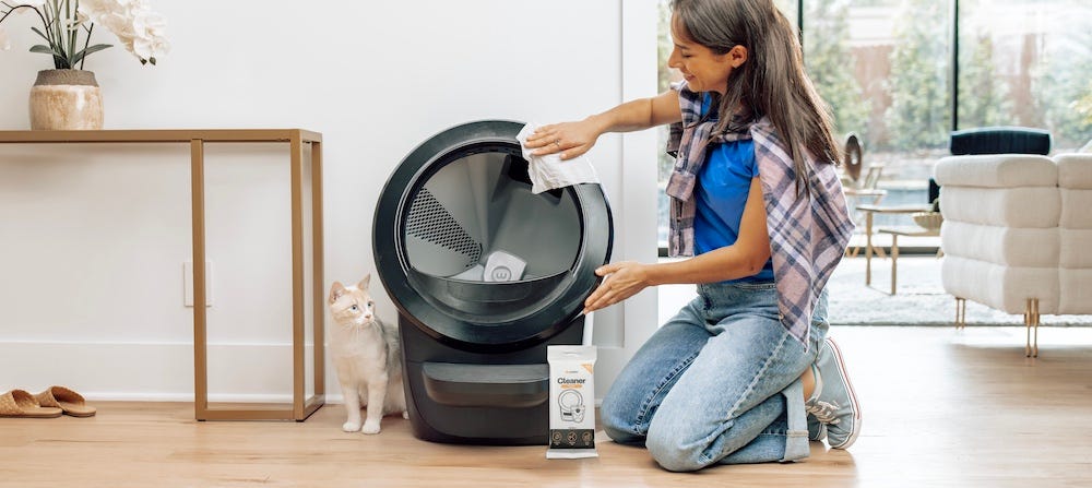 woman cleaning Litter-Robot automatic litter box