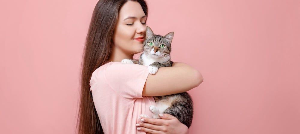 woman holding tabby cat
