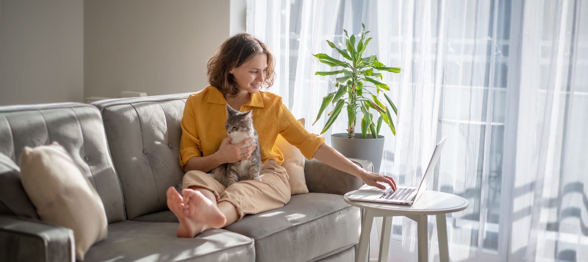 woman with cat on lap in apartment