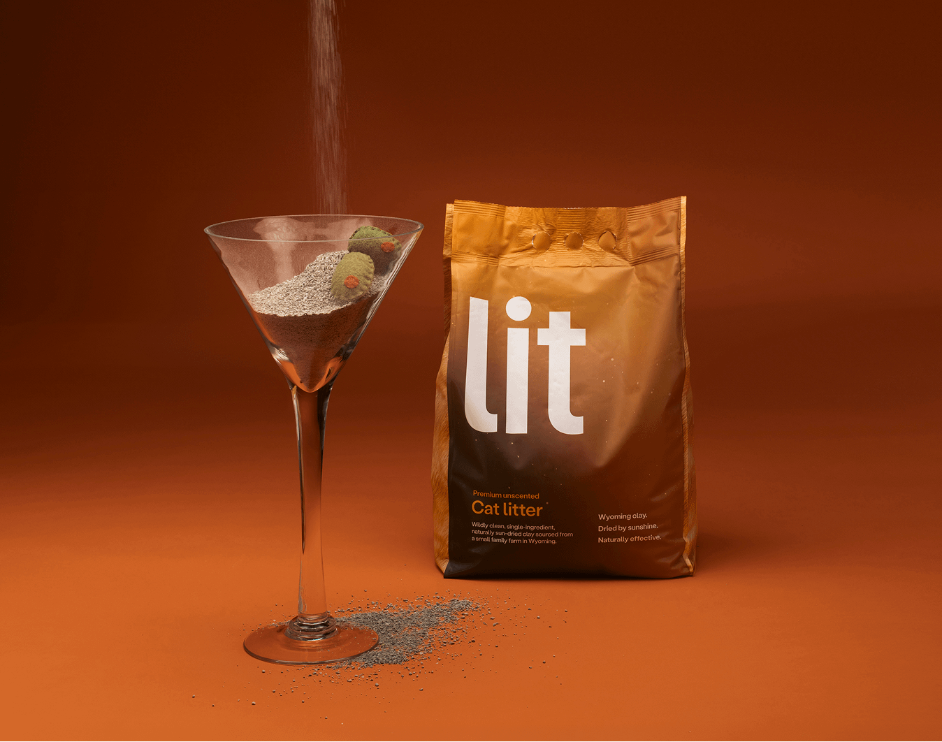 martini glass of clumping cat litter next to bag of Lit
