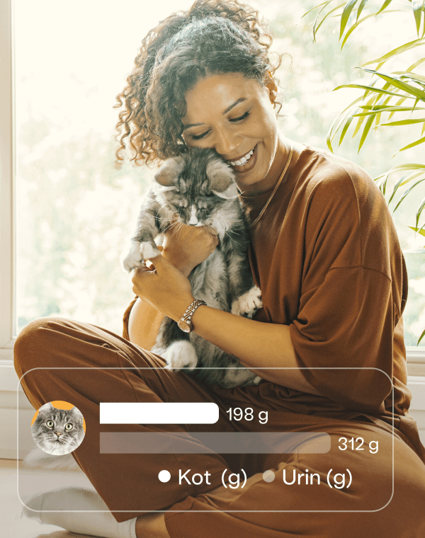 Smiling woman cuddling a fluffy gray cat, with an app overlay displaying waste tracking data: 198g feces and 312g urine