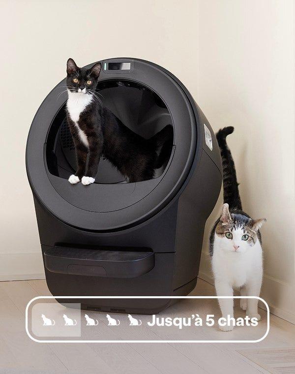 Two cats posed in front of a black Litter-Robot 5 with a badge reading 'Up to 5 cats'