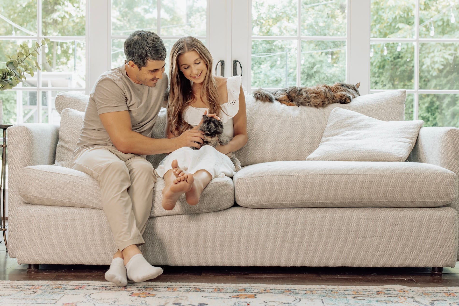 Jacob Zuppke and his wife sitting in home with their two cats