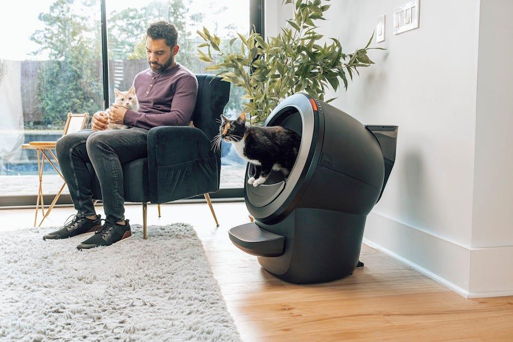 man sitting with cat next to Litter-Robot 4 LitterHopper