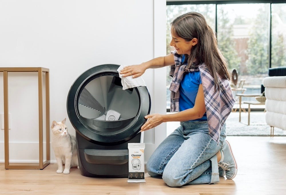 woman wiping down Litter-Robot 4 automatic litter box
