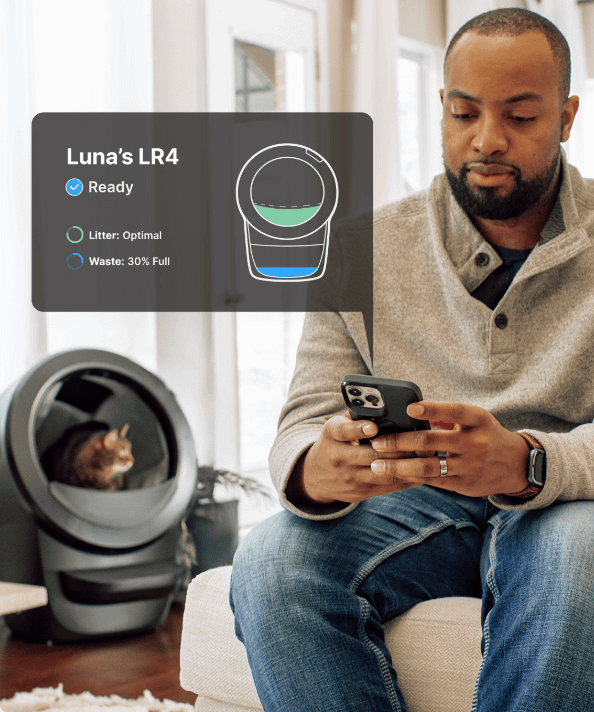 man looking at Litter-Robot 4 stats on Whisker app on phone