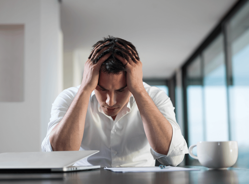 man sitting stressed at table