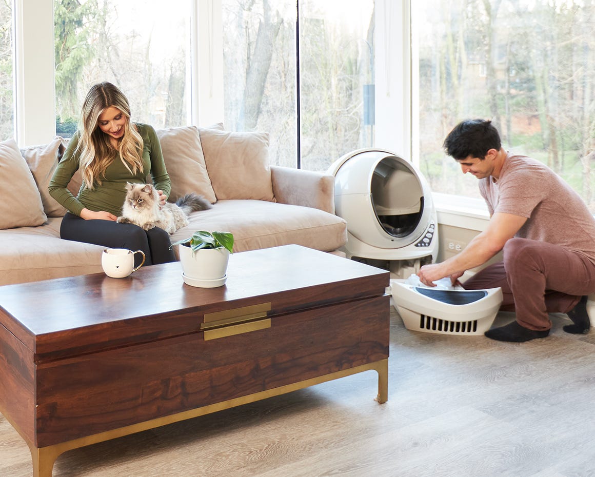 Person installing waste drawer liner