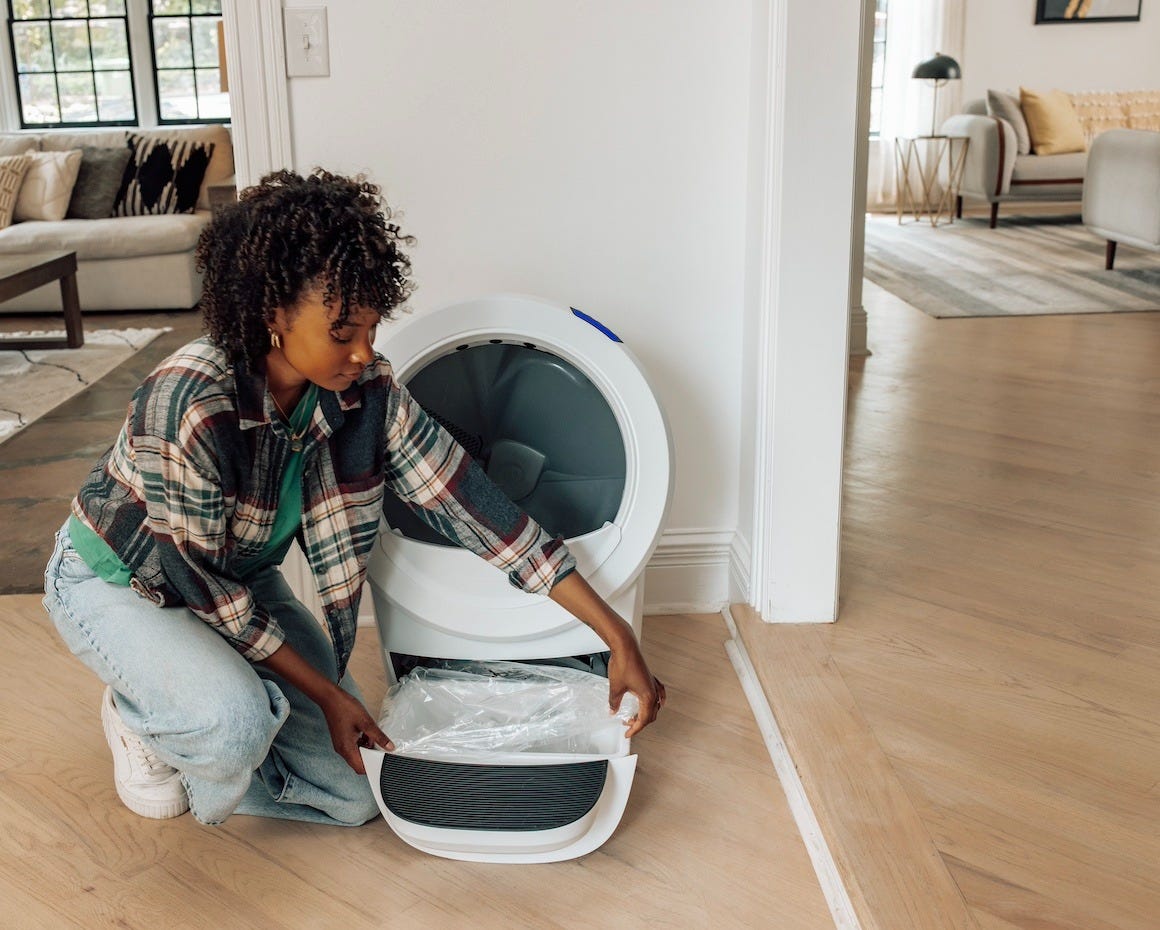 woman installing custom-fit waste drawer liner on Litter-Robot 4