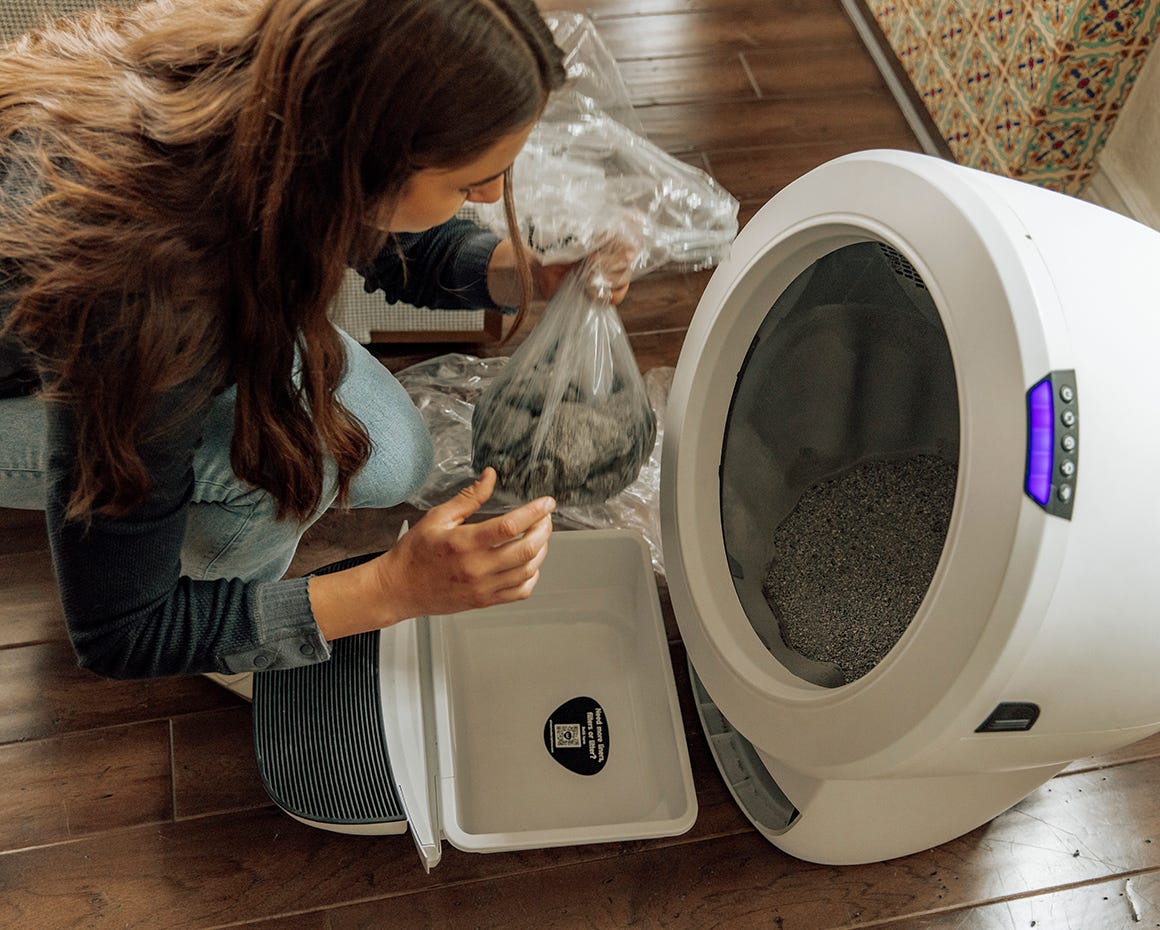 Women emptying Litter-Robot