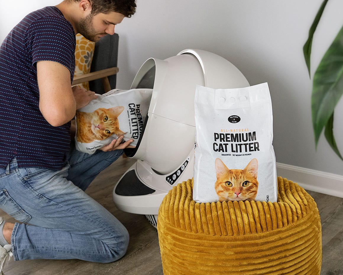 Man pouring premium cat litter into a Litter Robot 3