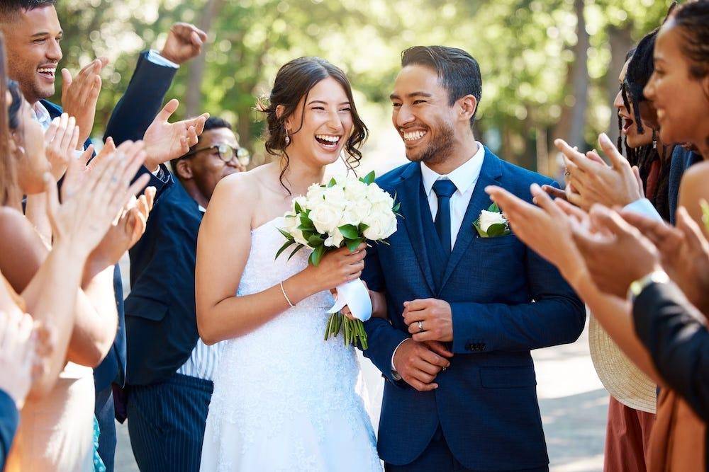 bride and groom happy with wedding guests