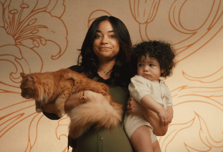 pregnant mom holding toddler and cat