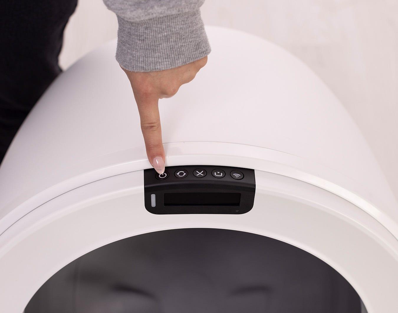 Litter-Robot 4 next to a traditional litter box