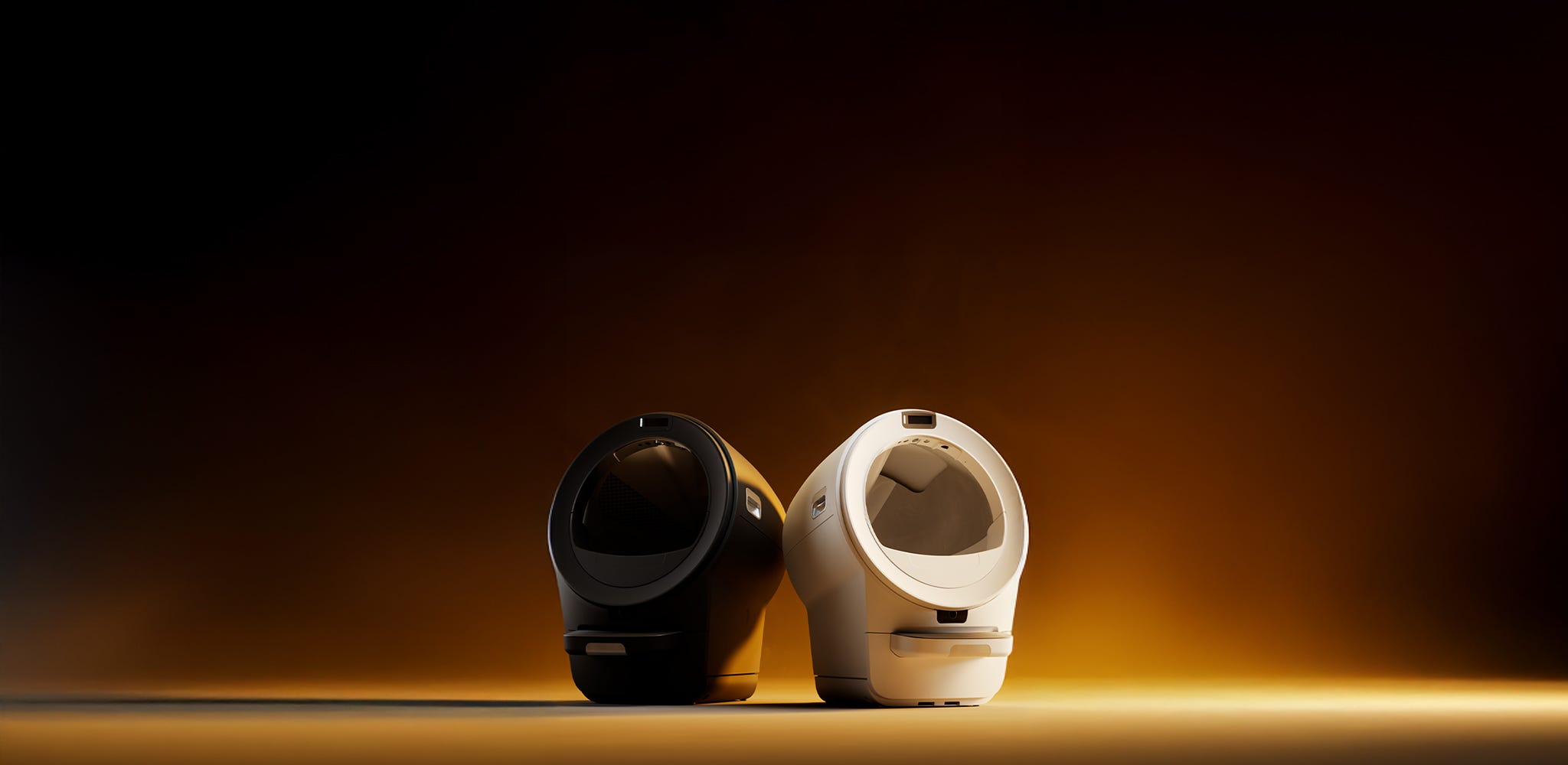 Two Litter-Robot 5 Pro automatic litter boxes in black and white