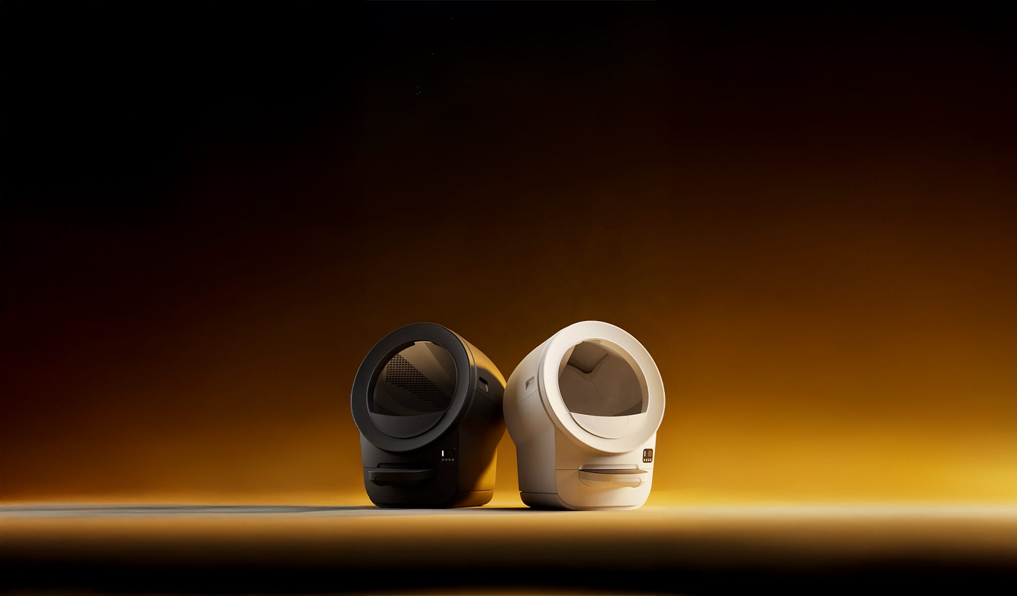 Two Litter-Robot EVO automatic litter boxes in black and white