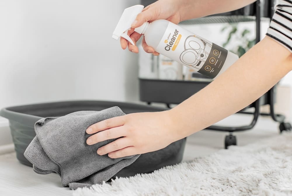 spraying the litter box with an enzyme cleaner